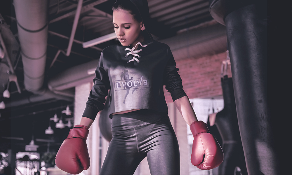 Cover photo, girl training in an Evolve Kickboxing sweater